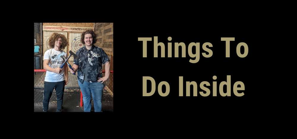 Things To Do Inside with photo of person on a Top Notch Axe Throwing Shirt crossing axes with a person in a printed shirt